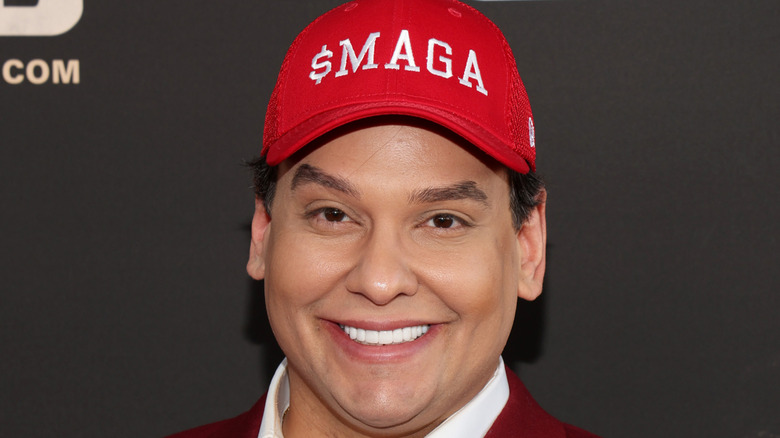George Santos wearing a $MAGA hat at an event