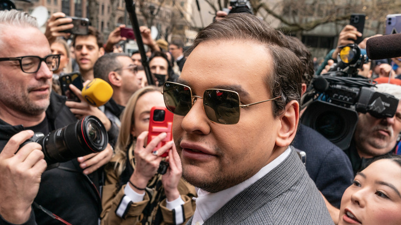 George Santos surrounded by photographers