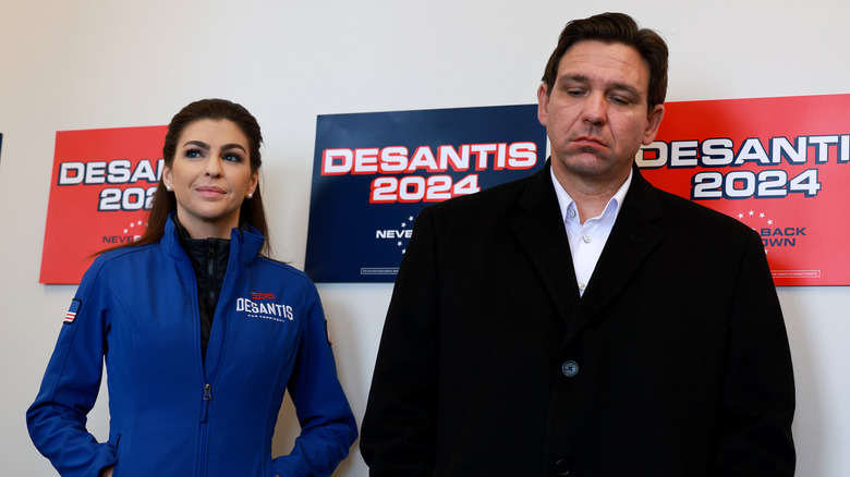 Ron DeSantis looking miserable next to his wife, Casey DeSantis.
