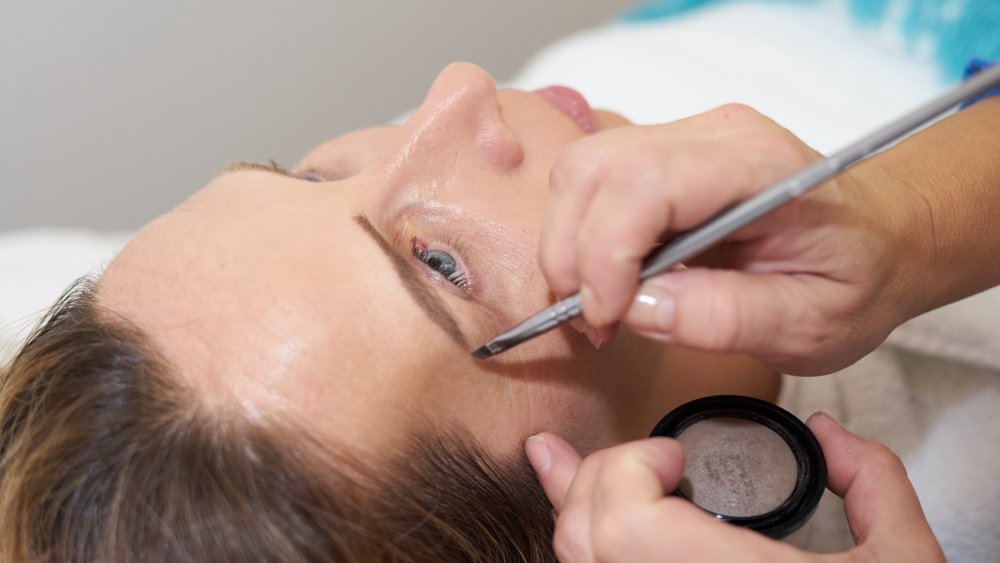 Woman getting eyebrow shaping