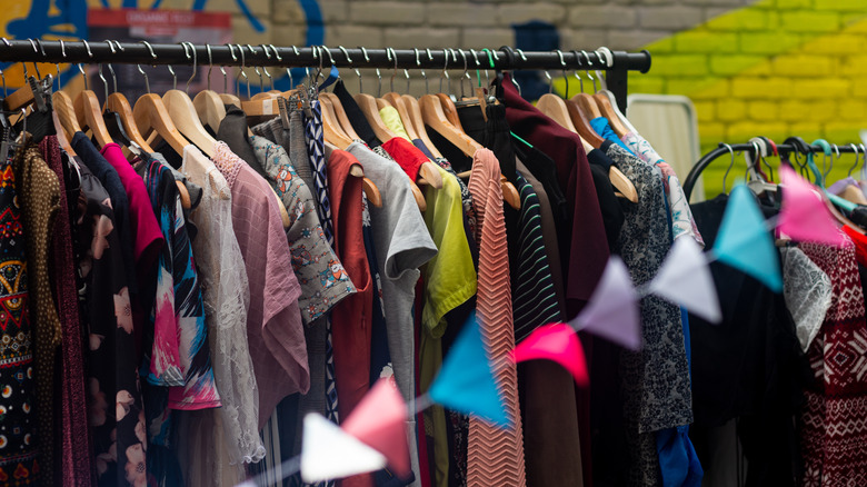 colorful second hand clothes on hangers 