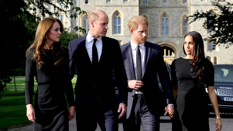 Kate Middleton, Prince William, and Prince Harry looking at Meghan Markle