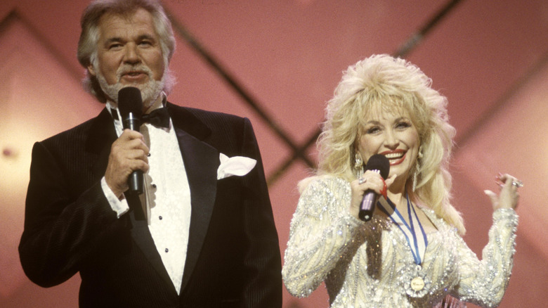 Dolly Parton and Kenny Rogers performing on stage in the 1990s