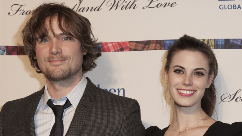 John Reardon and Meghan Ory smiling at an event