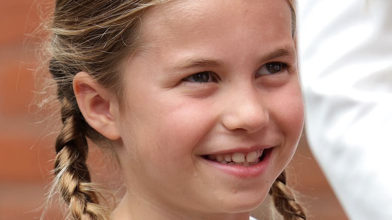 Princess Charlotte smiling in pigtails