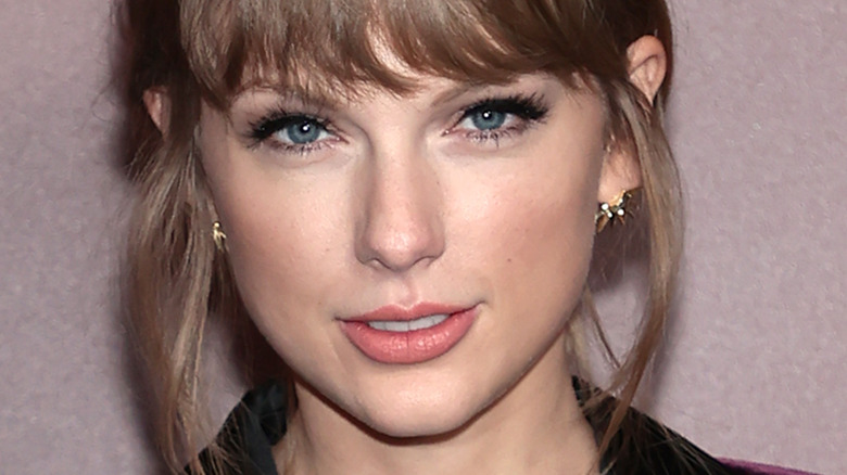 Taylor Swift with bangs and slight smile