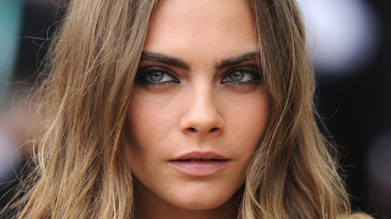 Cara Delevingne poses on the red carpet