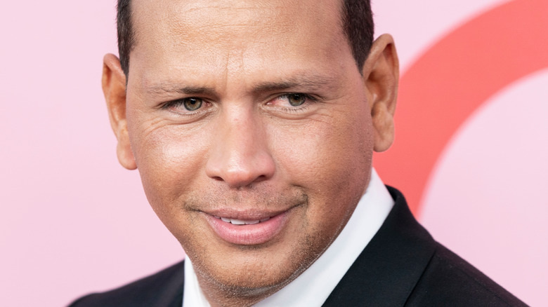 Alex Rodriguez smiling in dark suit