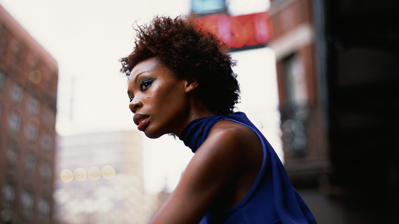 Woman wears blue sleeveless top