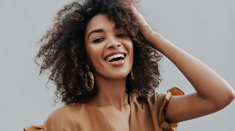 Woman touching her hair and smiling 