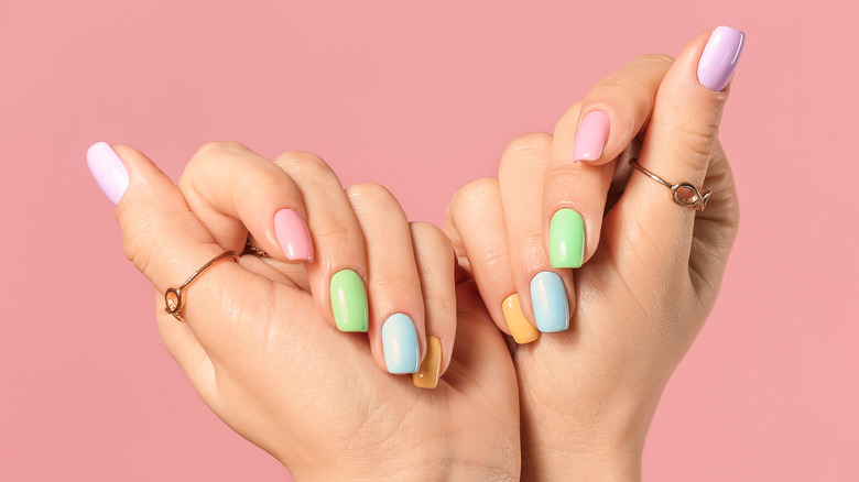 hands showing off colorful nails