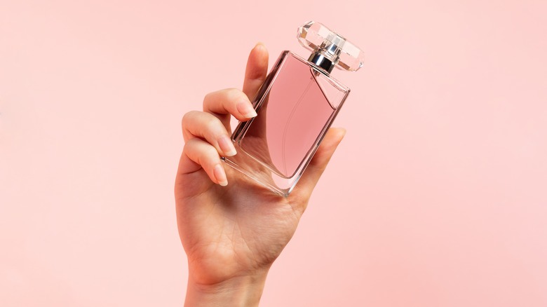 Woman holding perfume bottle