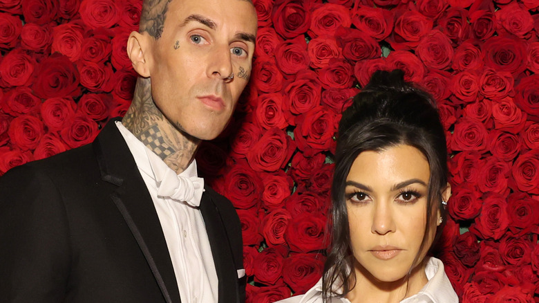 Travis and Kourtney with rose backdrop