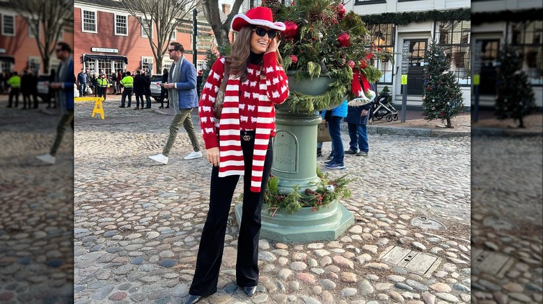 Kaitlan Collins smiling and wearing an all red-and-white outfit