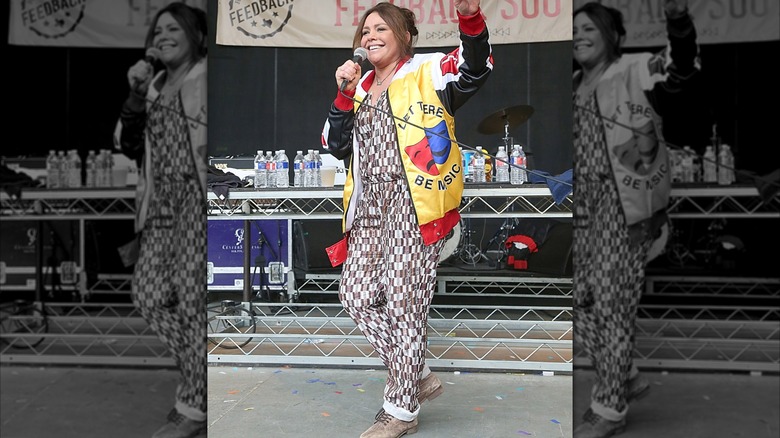 Rachael Ray waving and speaking into microphone