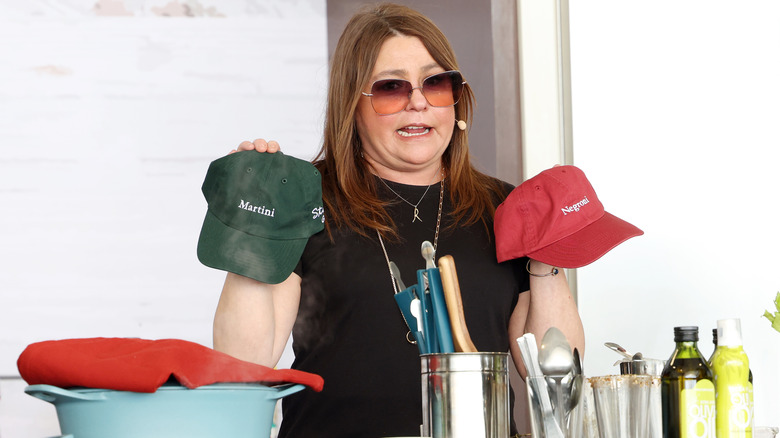 Rachael Ray holding up a pair of hats