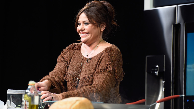 Rachael Ray smiling while using a vegetable slicer