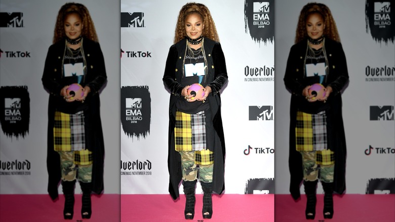 Janet Jackson smiling and holding an award