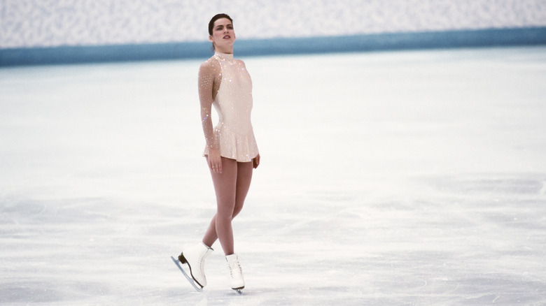 Nancy Kerrigan in champagne beaded Vera Wang skating dress on the ice at 1994 Olympics