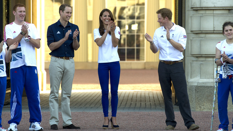 Prince William, Princess Kate, and Prince Harry clapping