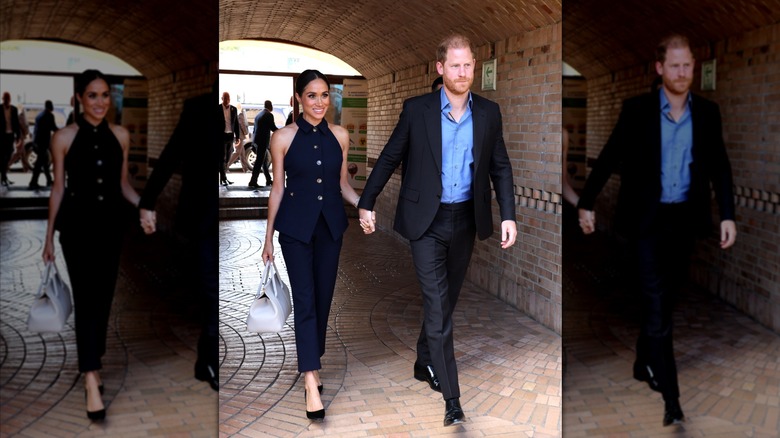 Meghan Markle wearing a matching black set while holding Prince Harry's hand in trip to Colombia.
