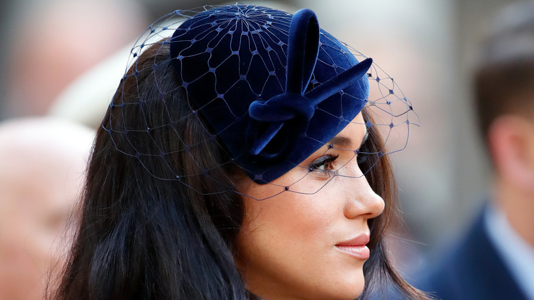 Meghan Markle wearing a royal blue fascinator at the 91st Field of Remembrance at Westminster Abbey in 2019.