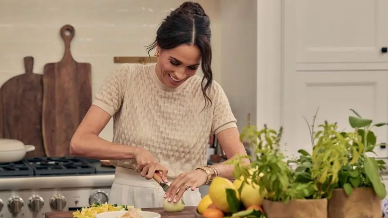 Meghan Markle wearing a beige sweater and matching pants on her Netflix cooking show, "With Love, Meghan."