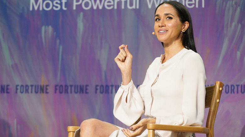 Meghan Markle wearing a white monochrome outfit while speaking at Fortune's Most Powerful Women Summit in 2025.