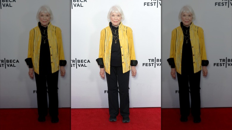 Ellen Burstyn in a yellow blazer, black shirt, and black pants in 2025