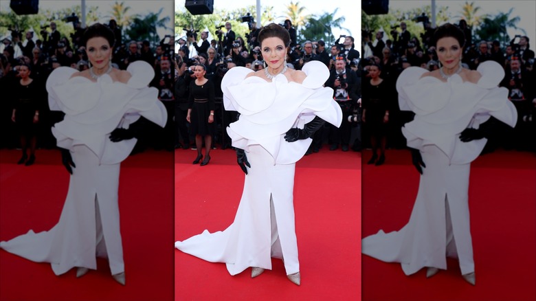 Joan Collins wearing a voluminous white dress at Cannes