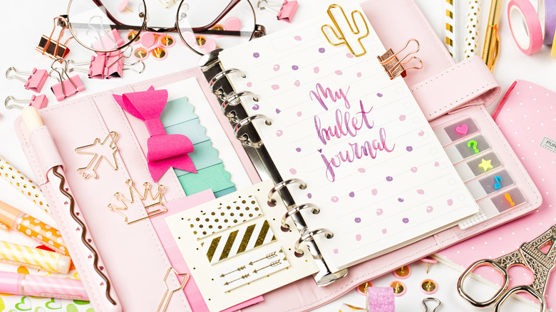 pink bullet journal with accessories 