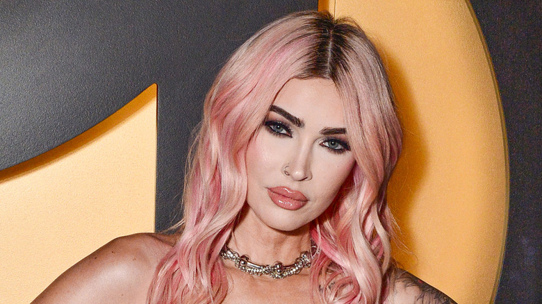 Megan Fox posing at an event in 2024 with pink hair