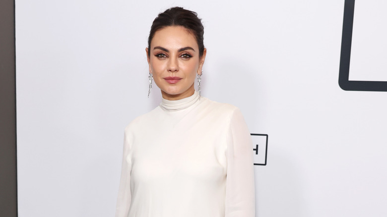 Mila Kunis posing at the "Goodrich" premiere in 2024