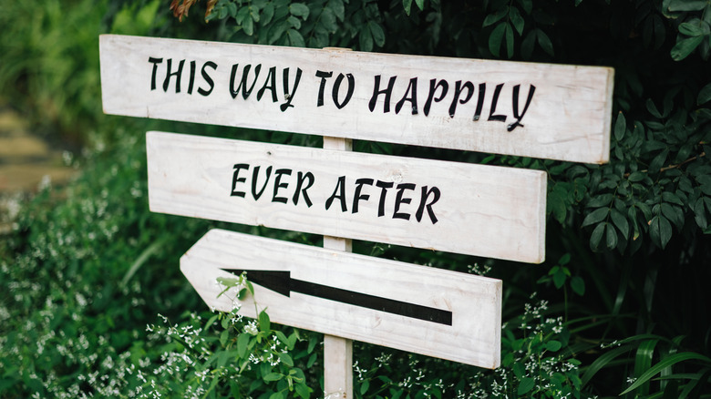 Sign reading this way to happily ever after