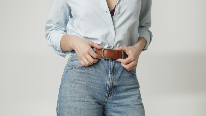 Woman showing off belt