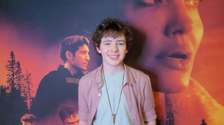 A young Finn Little posing for cameras on the red carpet
