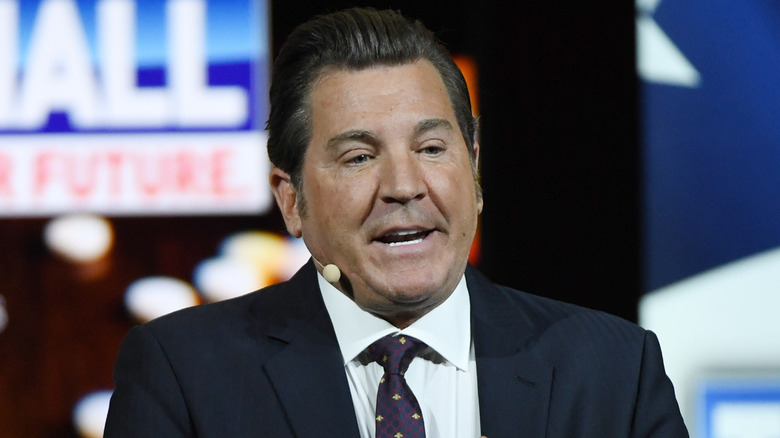 Eric Bolling speaking into headset microphone