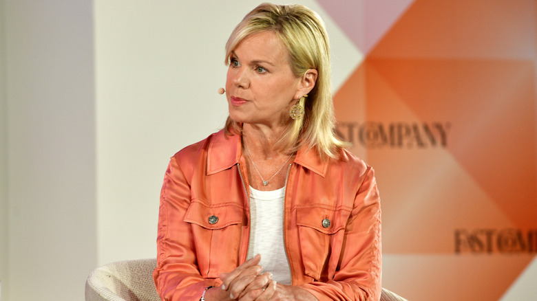 Gretchen Carlson sitting on stage wearing microphone headset