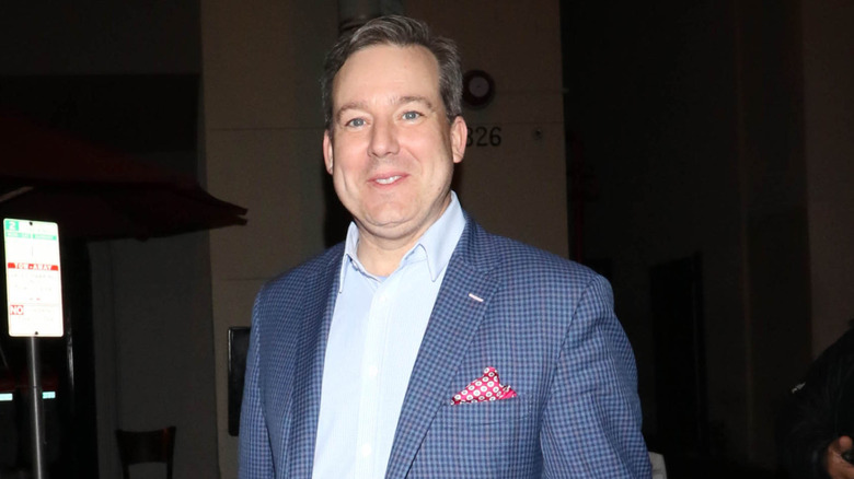 Ed Henry smiling and walking on the street