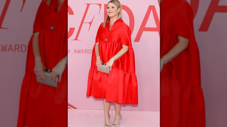 Jenna Bush Hager smiling and posing on the red carpet.