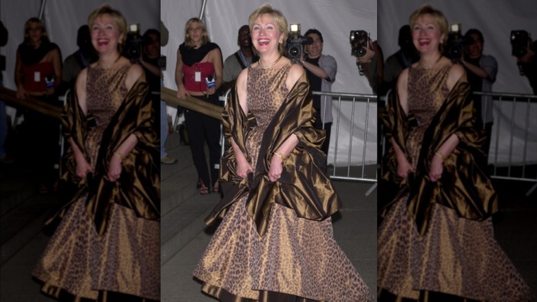 Hillary Clinton laughin in leopard print dress and red lipstick