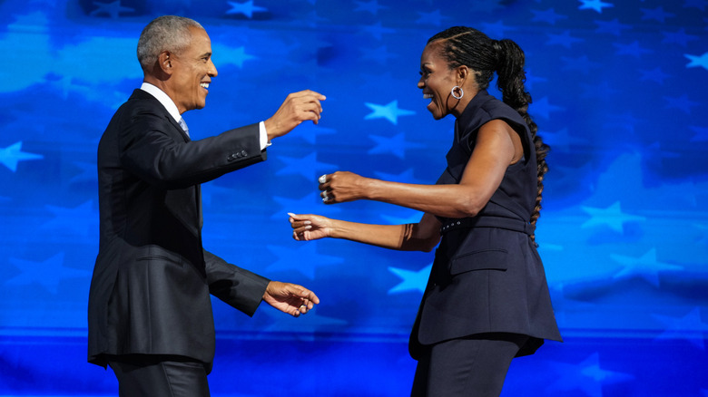 Barack and Michelle Obama getting ready to embrace each other