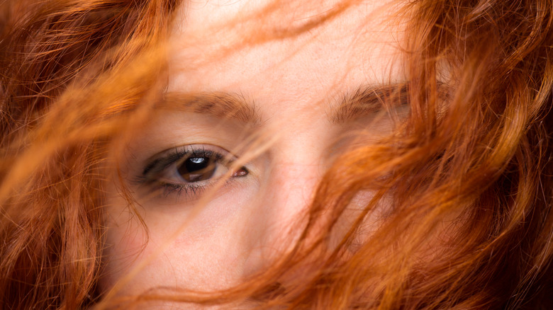 red hair covering woman's eyes