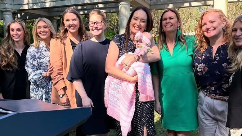 Sarah Huckabee Sanders poses for a group photo with Secretary Brooke Rollins