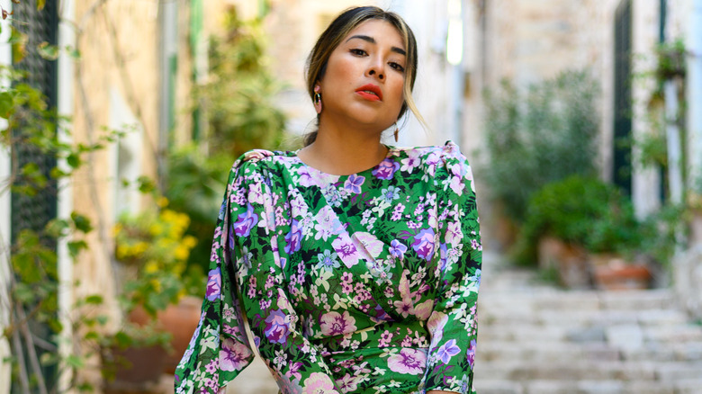 woman wearing green dress with purple flowers