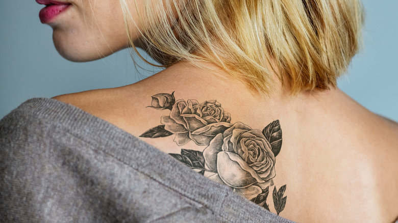Rose tattoo on woman's back