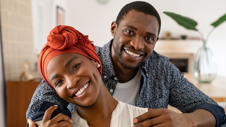 smiling couple holding each other