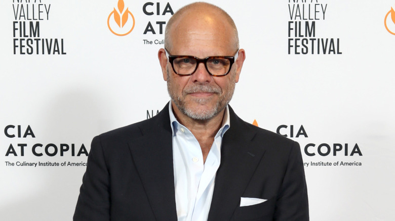 Alton Brown posing in front of a white background at the Napa Valley Film Festival