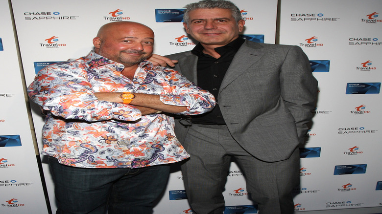Andrew Zimmern posing with Anthony Bourdain