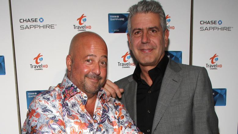 Andrew Zimmern posing with Anthony Bourdain